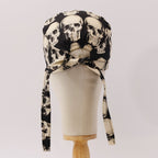Back view of skulls on dark grey scrub cap showing tie closure detail