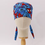 Back view of Spiderman Comic Web Grid scrub cap showing blue fabric with red spider faces and tie details