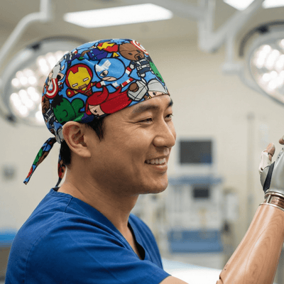 Marvel Avengers Cartoon Fighting Brawl scrub cap shown on model