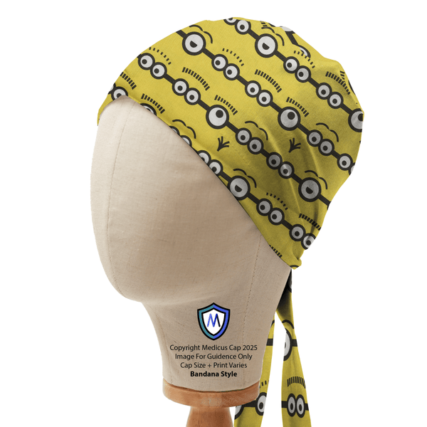 Bandana-style scrub cap by Medicus Caps with a playful Minions eyes design, displayed on a mannequin to showcase its fun pattern and fit.
