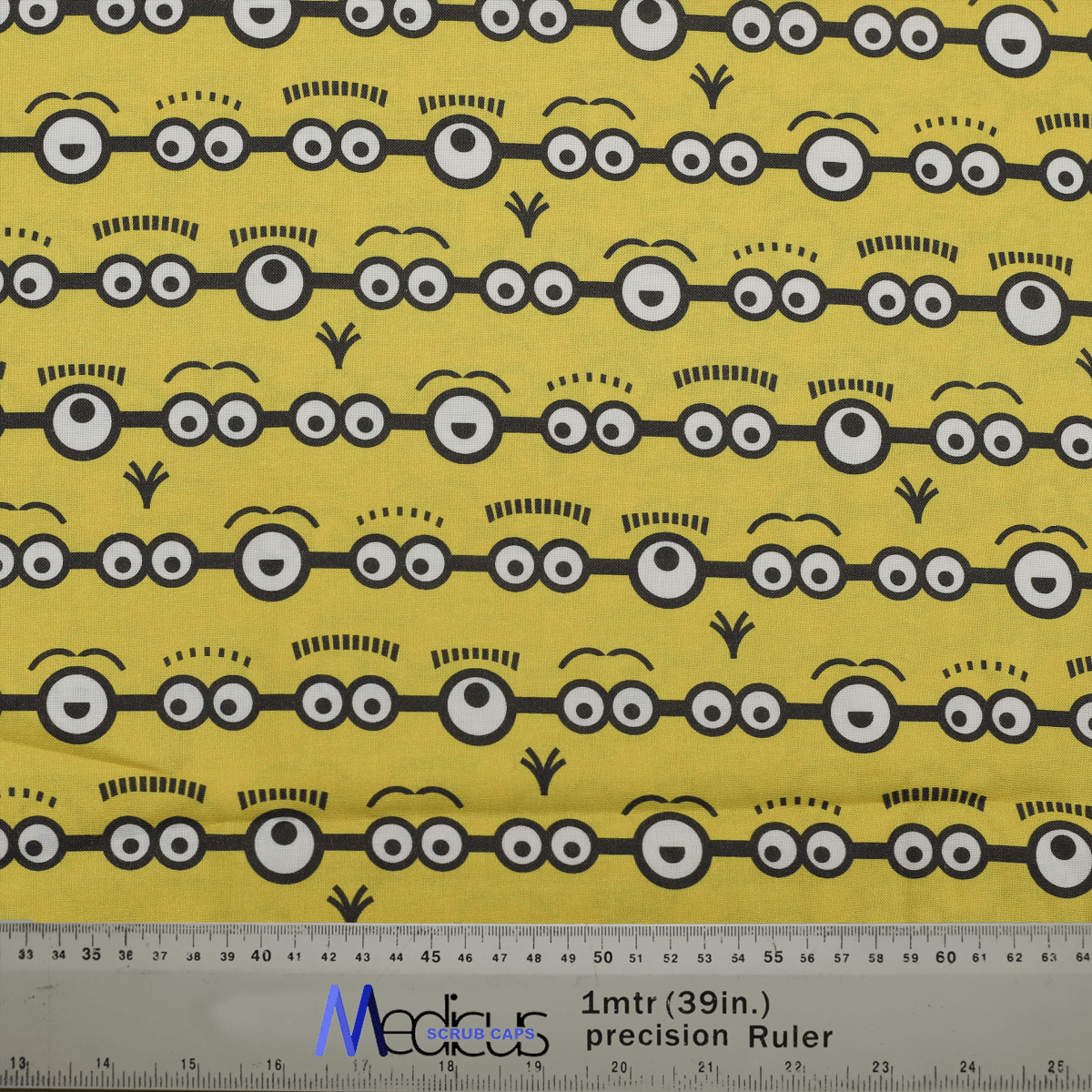 Fabric pattern with Minions eyes on a yellow background by Medicus Caps, designed for fun and playful scrub caps.