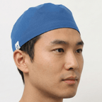 Blue Crown scrub cap shown in side profile view on male model