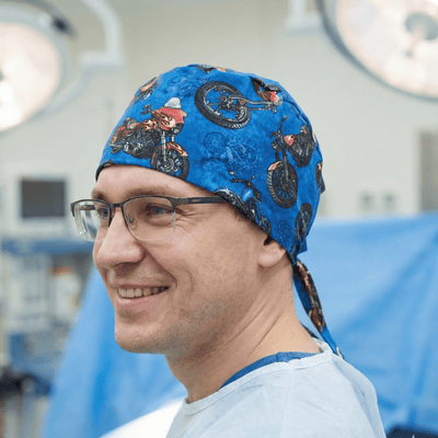 Dark blue motorcycle pattern scrub cap with vintage bike prints and tie-back design