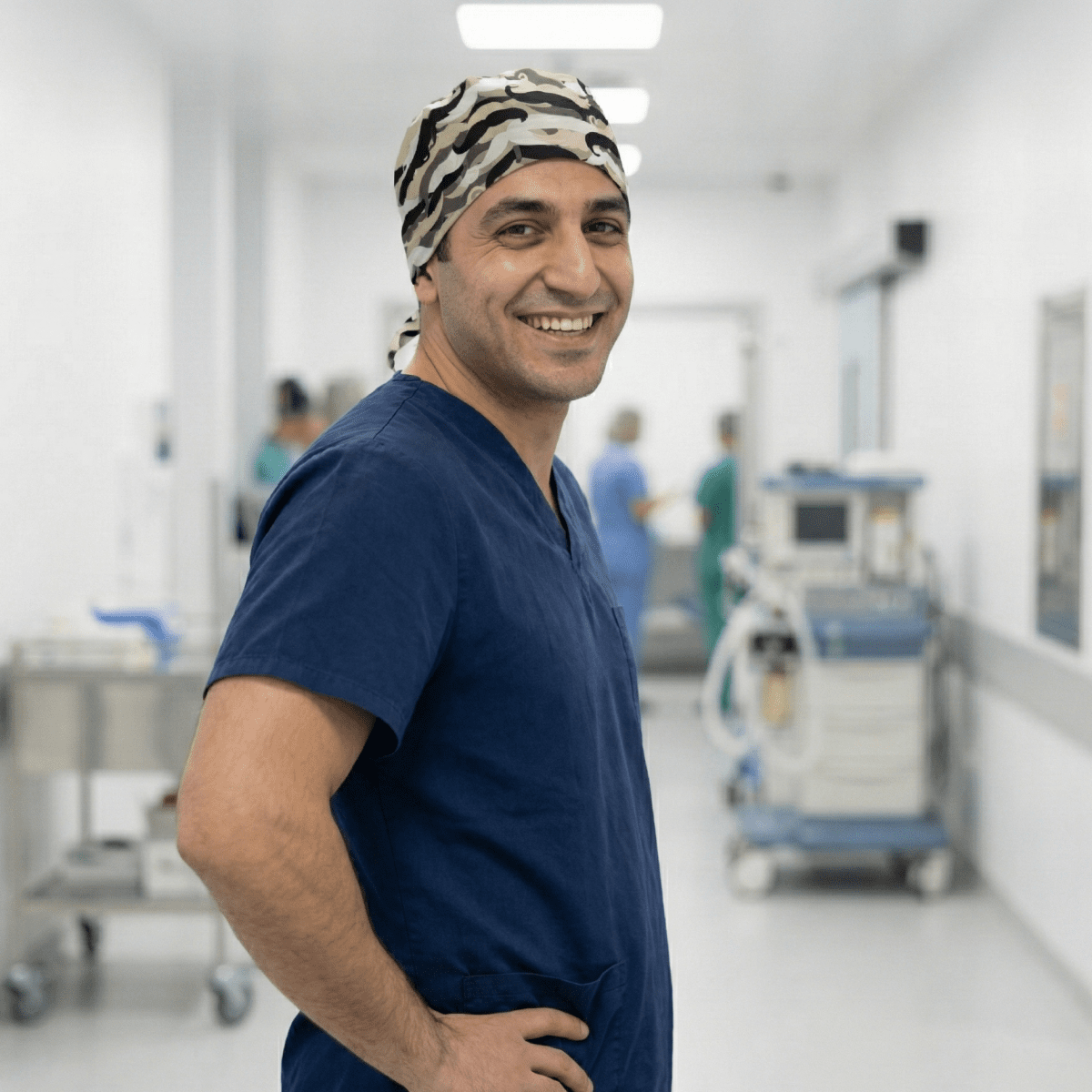 Healthcare professional wearing Moustache Madness scrub cap with black mustache pattern on gray background