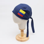 Navy blue scrub cap with Colombian flag vinyl transfer shown in side profile view
