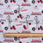 Close-up view of Nightmare Before Christmas scrub cap showing Jack Skellington, presents, and "Season's Creepings" text pa...