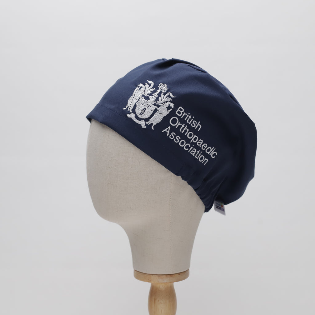 Navy blue Medicus Scrub Cap with British Orthopaedic Association logo, displayed on a mannequin head. @boa-official-scrub-cap