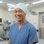 Healthcare professional wearing light blue Winter Leaves scrub cap with small leaf pattern in operating room