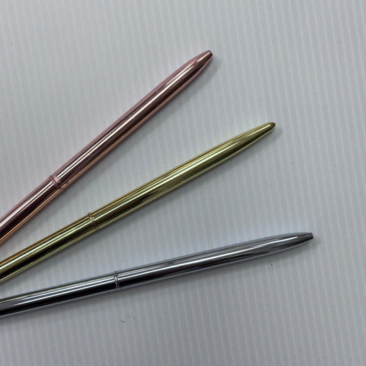 Metal chrome-plated pens from Medicus Scrub Caps in rose gold, gold, and silver, displayed on a textured white background.