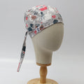 Side view of grey custom scrub cap featuring cartoon dogs and cats with hearts and bones. Handmade pet lover scrub cap by Medicus Caps with long tie strap, ideal for veterinary or medical professionals.