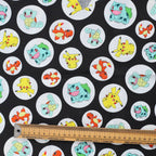 Close-up detail of Pokemon Black Circles scrub cap showing colorful Pikachu, Squirtle and other characters in white circles
