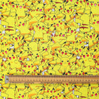 Close-up view of bright yellow Pikachu pattern scrub cap fabric with Pokemon characters scattered throughout