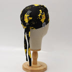 Back view of Pokemon Pikachu yellow on black scrub cap showing tie closure and pattern detail