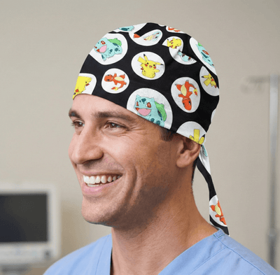 Black scrub cap with colourful Pokemon character circles pattern and tie-back closure