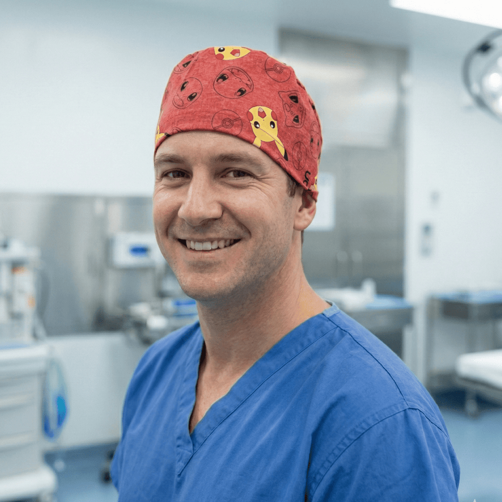 Smiling healthcare worker wearing red Pokemon scrub cap with Pikachu and characters in hospital setting