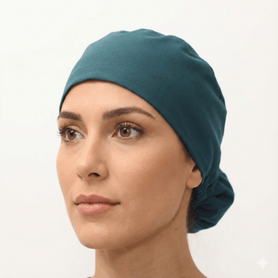 Teal green reusable scrub cap with ponytail opening and tie-back design