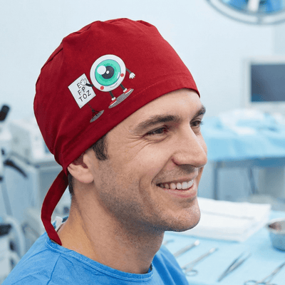 Red scrub cap with eye chart design featuring cartoon eyeball and surgical tools