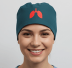 Teal scrub cap with red lungs vinyl transfer design worn by smiling healthcare professional