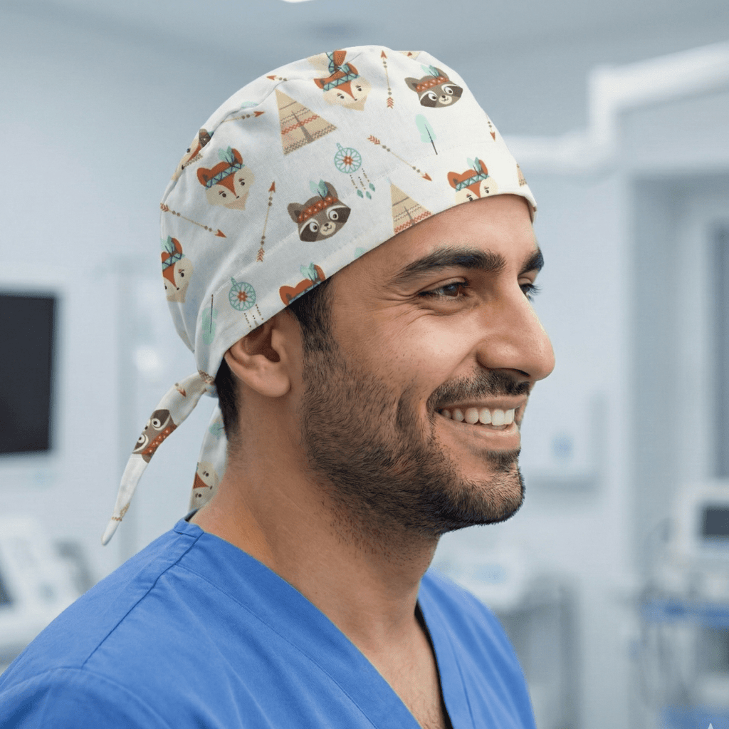 White scrub cap with brown raccoon and orange teepee pattern, tie-back design