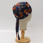 Back view of dachshund patterned scrub cap showing navy blue fabric with orange and brown sausage dogs