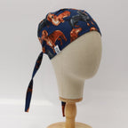 Navy blue scrub cap with cartoon dachshund dogs pattern shown on mannequin head side view