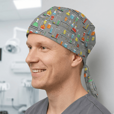 Colourful science laboratory pattern scrub cap with Bunsen burners and beakers on grey