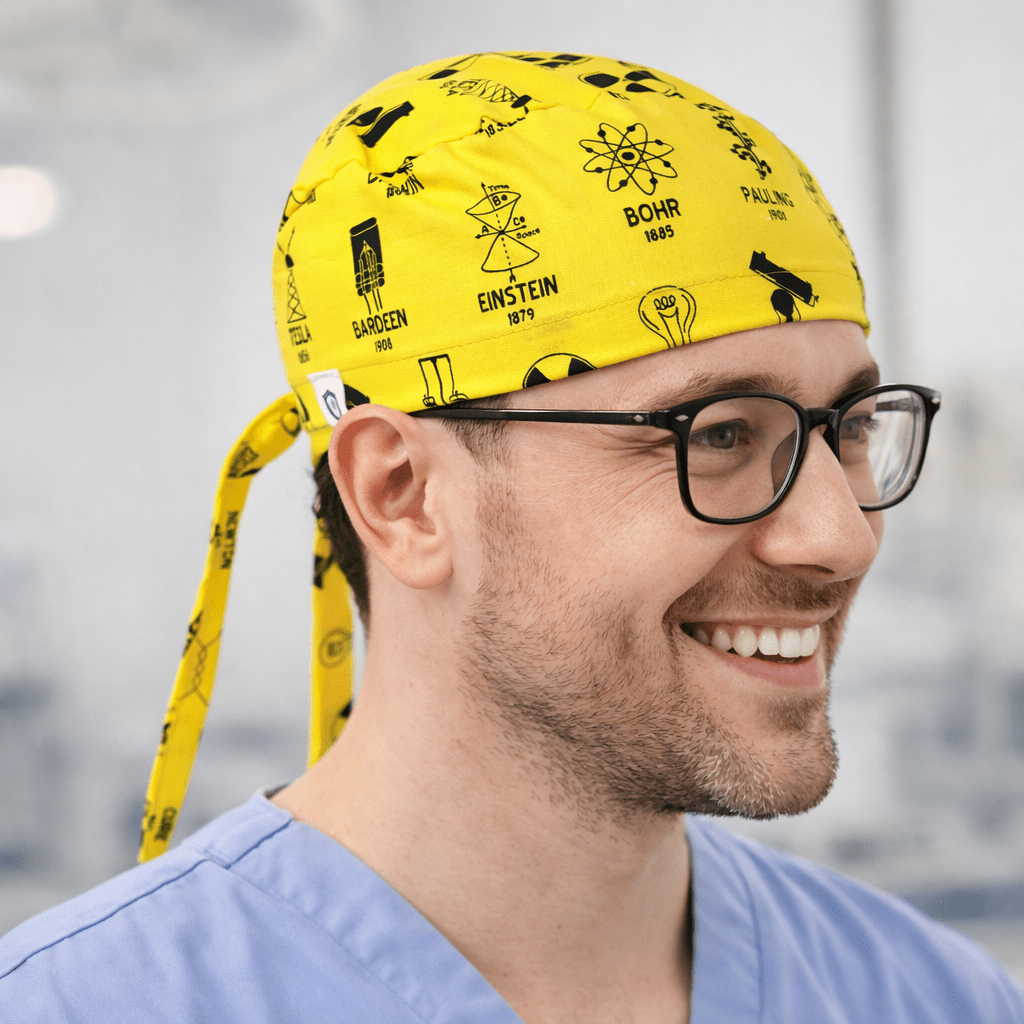 Side profile of yellow science founders scrub cap with Einstein and physics symbols pattern