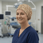 Healthcare worker wearing beige Scrabble letters patterned scrub cap, front view in operating room