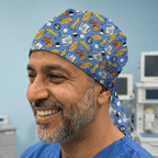 Royal blue scrub cap featuring Seinfeld breakfast themed cartoon pattern with cereal boxes