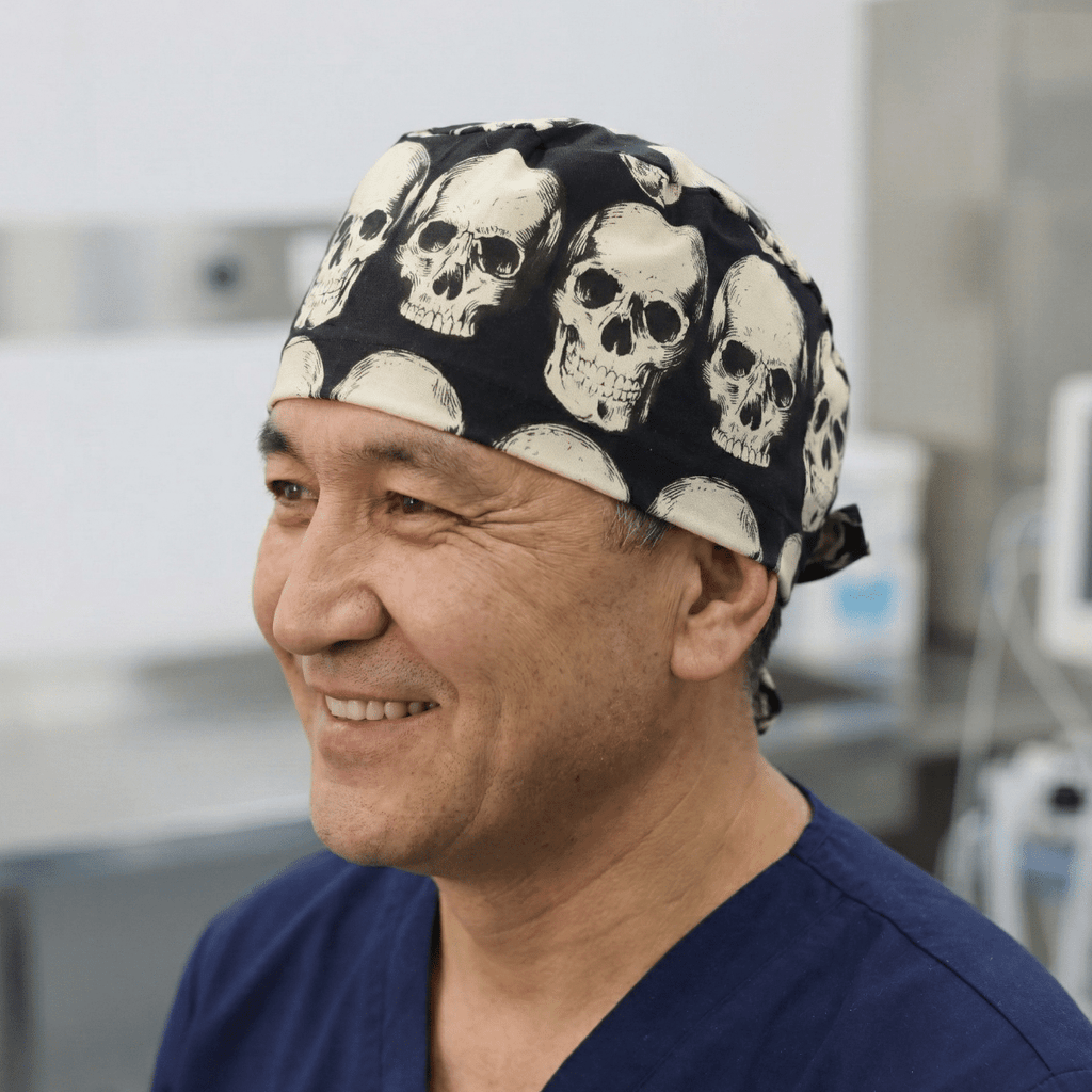 White skull pattern on dark grey reusable scrub cap with tie-back design