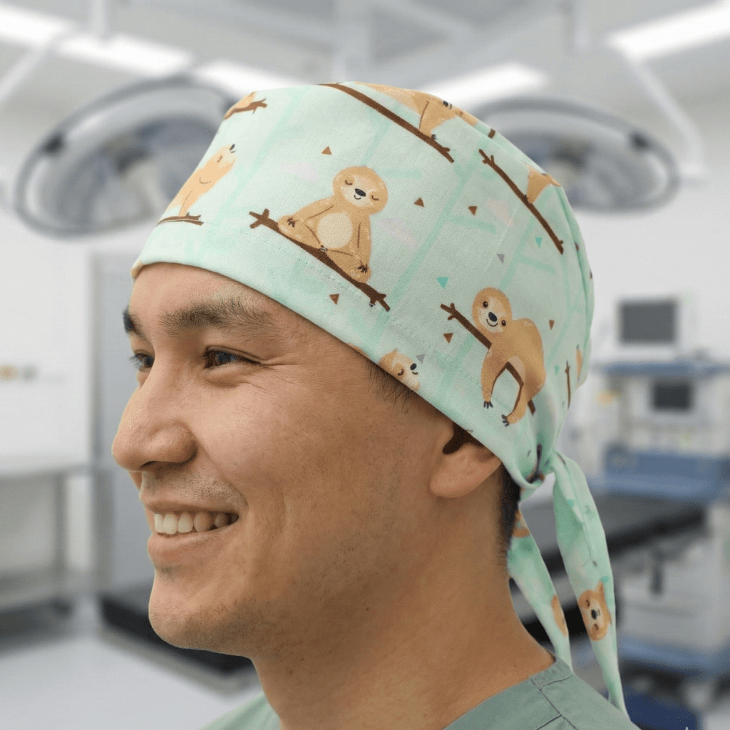 Mint green sloth pattern scrub cap with cute sloths on branches design