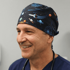 Space-themed scrub cap featuring rockets, planets and galaxies on black background