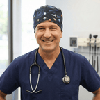 Navy space-themed scrub cap with planets and rockets pattern worn by smiling medical professional