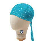 Mannequin head wearing a teal Medicus Scrub Cap with white sperm motifs in captain style.