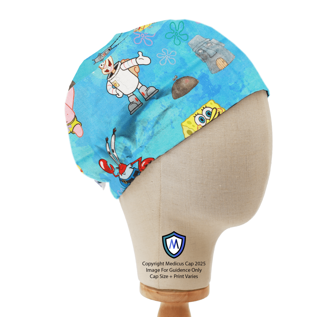 On a blue background, a mannequin head wears the Medicus Scrub Caps Spongebob + Friends Scrub Cap, featuring playful animated characters for a fun, stylish look.