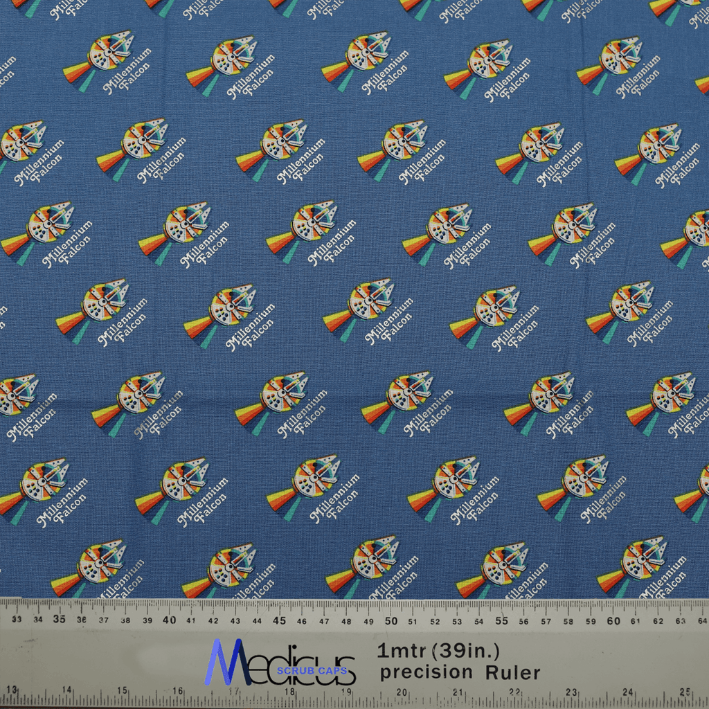 Close-up of Star Wars Pride Millennium Falcon fabric with ruler for scale, used in Medicus Scrub Caps mini scrub caps.