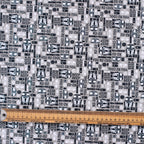 Close-up detail of gray and black R2D2 Star Wars patterned scrub cap fabric with measuring ruler