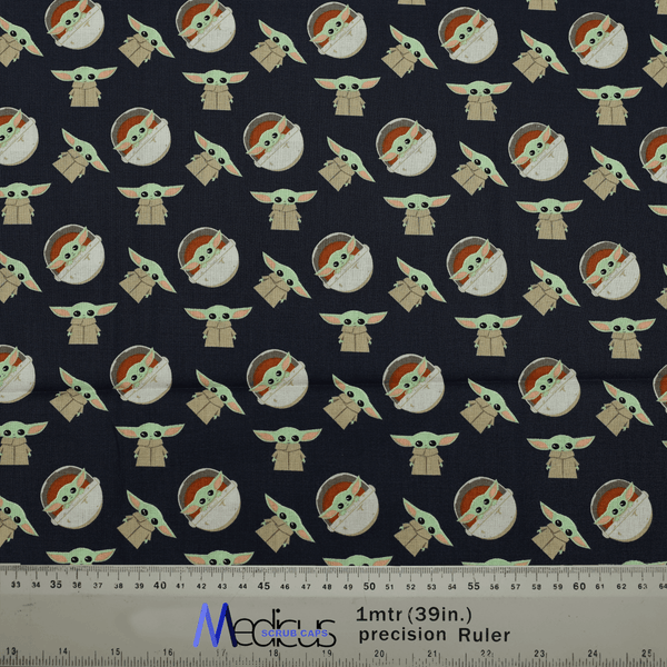 Close-up of Baby Yoda kawaii fabric pattern with a ruler for scale, used in Medicus Scrub Caps' "Star Wars Baby Yoda Kawaii" scrub cap.