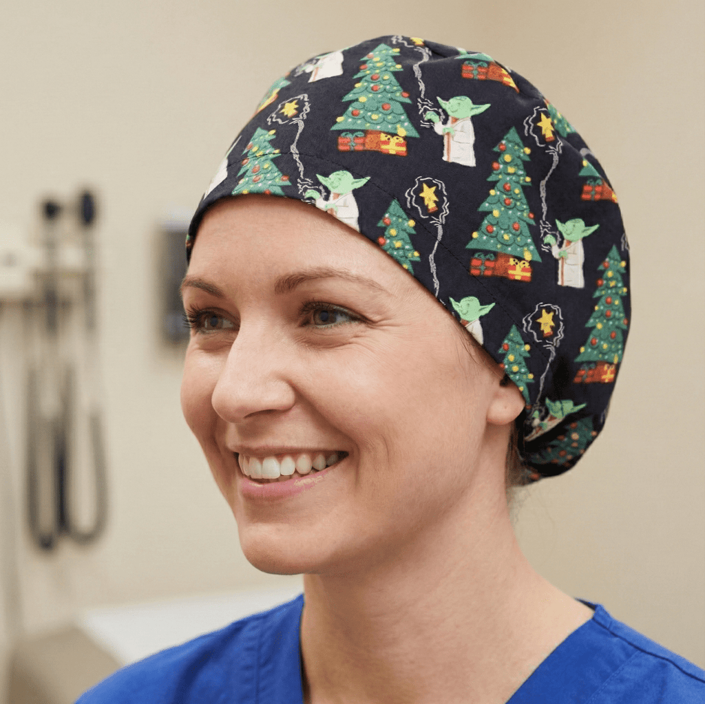 Navy blue Star Wars Christmas Yoda print scrub cap with green Christmas trees pattern