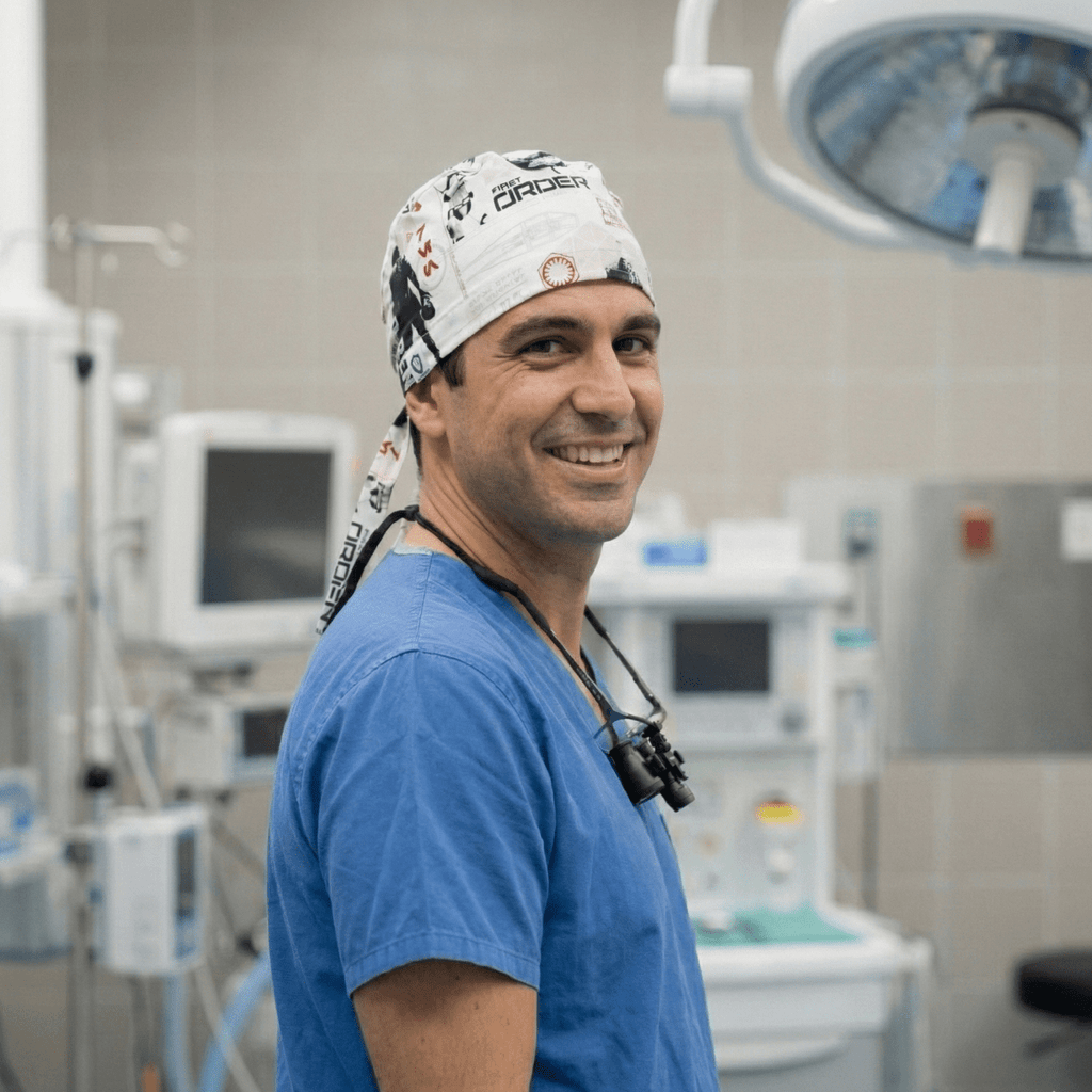 Medical professional wearing white Star Wars patterned scrub cap with ties, side profile view in operating room