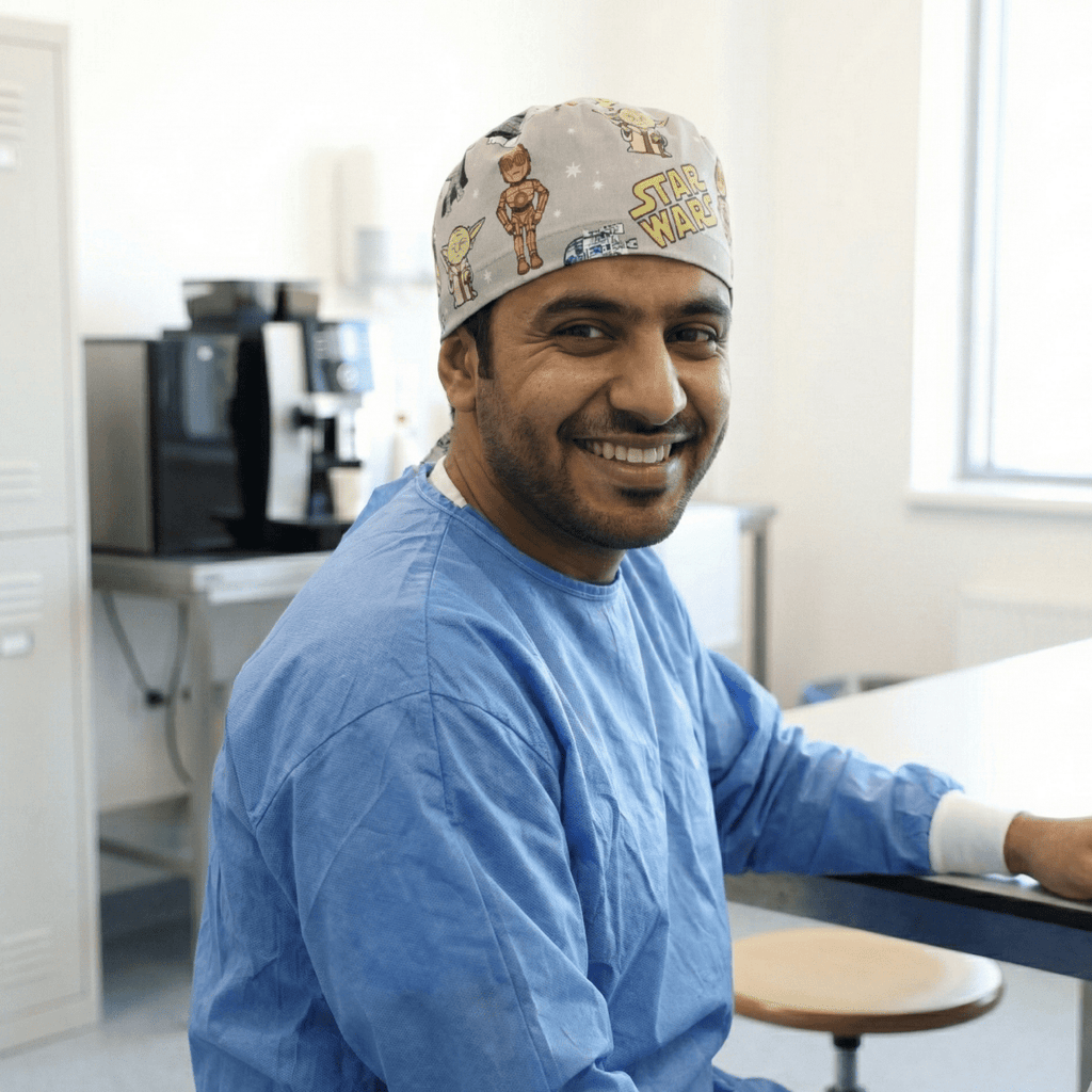 Healthcare worker wearing Star Wars kawaii print scrub cap with cute character designs, side profile view
