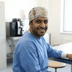 Healthcare worker wearing Star Wars kawaii print scrub cap with cute character designs, side profile view