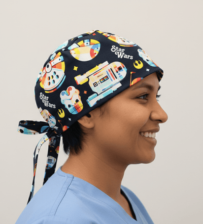Navy blue Star Wars themed scrub cap with colourful spaceships and tie-back design