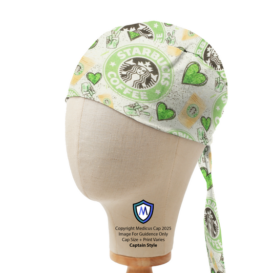 A mannequin head displays a Starbucks Love Green Hearts Scrub Cap by Medicus Scrub Caps, featuring Starbucks logos, green hearts, and coffee-themed designs.