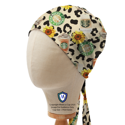 Mannequin head wearing a Medicus Scrub Cap with Starbucks logos, pumpkin spice lattes, sunflowers, and leopard print in a bandana style.