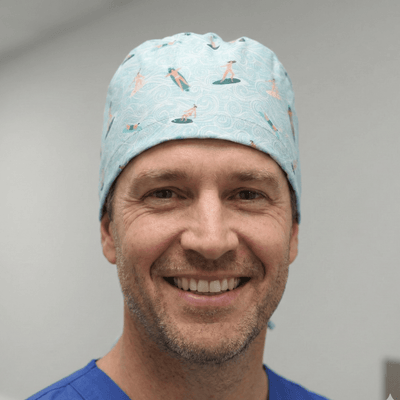 Light blue surfer pattern scrub cap with orange and white surfboard designs