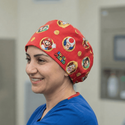 Red Super Mario character print scrub cap with colourful gaming icons and logos