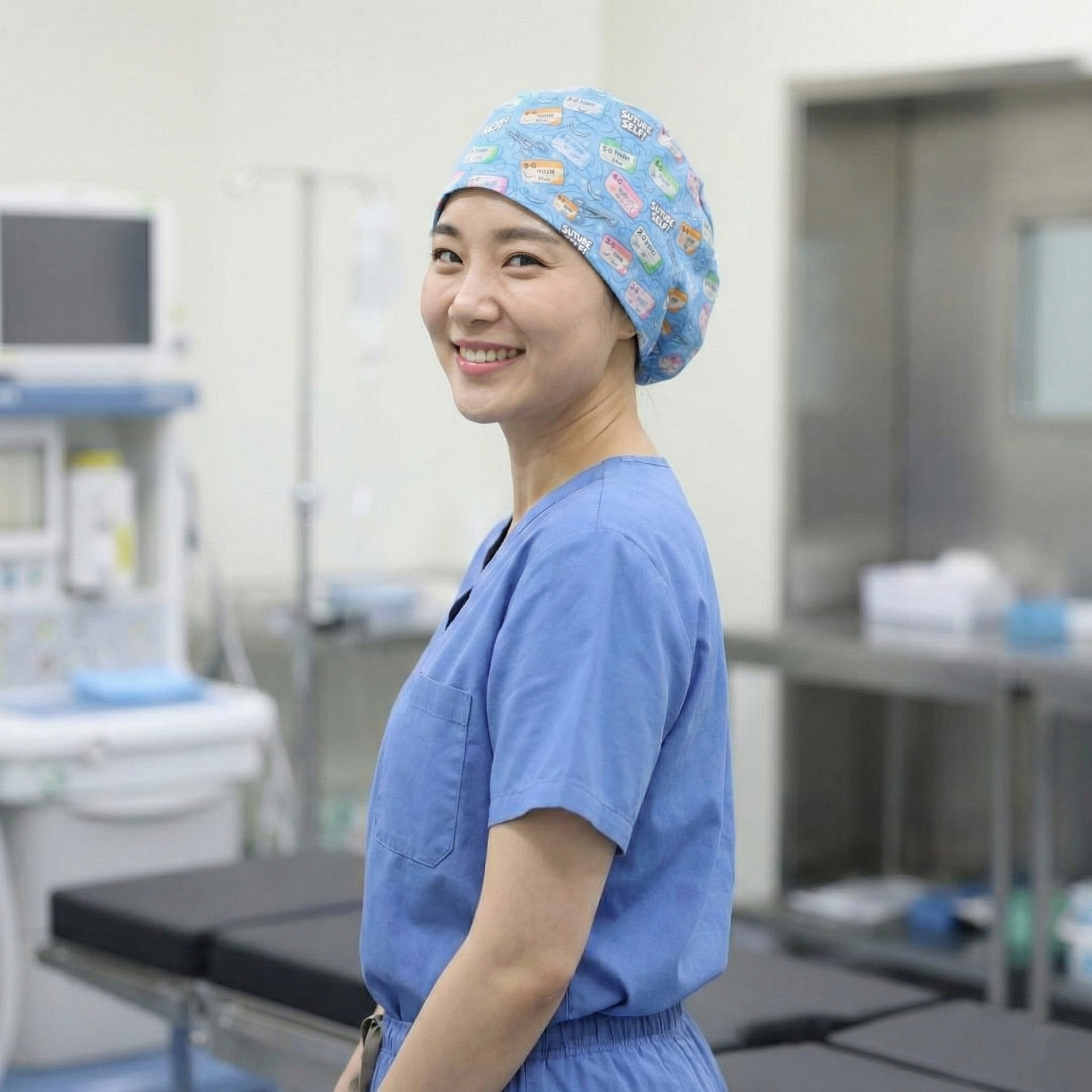Healthcare worker wearing blue patterned Suture Self scrub cap, side profile view in medical setting