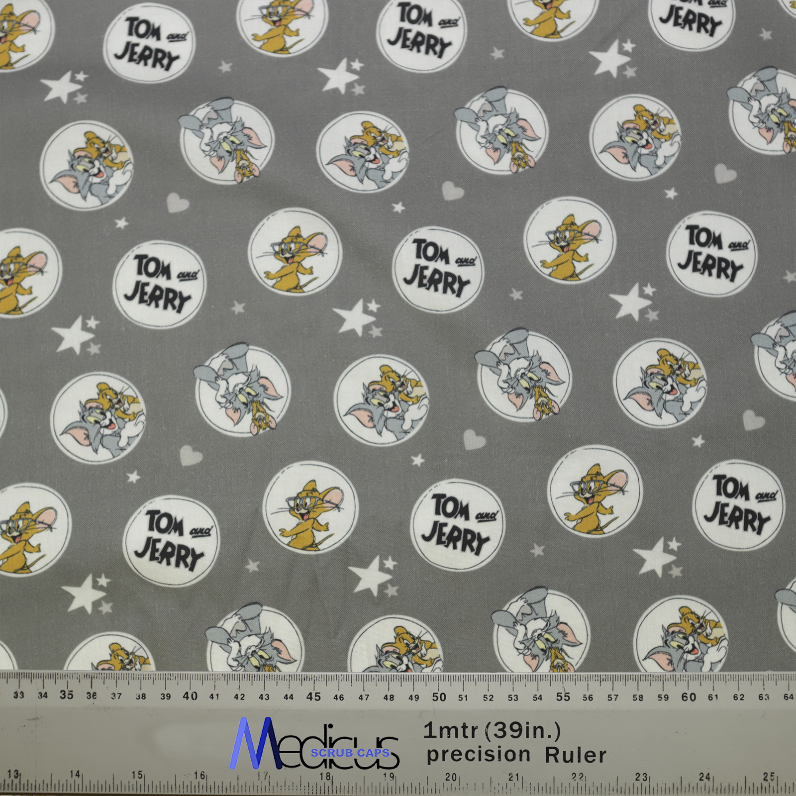 Tom And Jerry Circles Grey Scrub Cap from Medicus Scrub Caps, featuring a playful cartoon pattern on a grey background with stars and hearts.