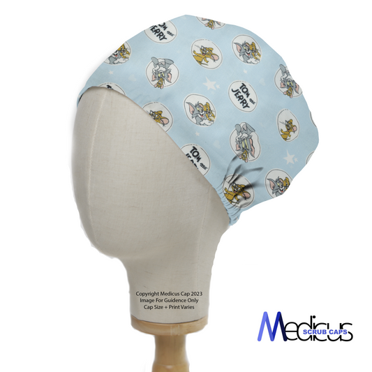 The Tom And Jerry Circles On Blue Scrub Cap by Medicus Scrub Caps features playful cartoon characters on light blue, displayed on a mannequin head with branding.